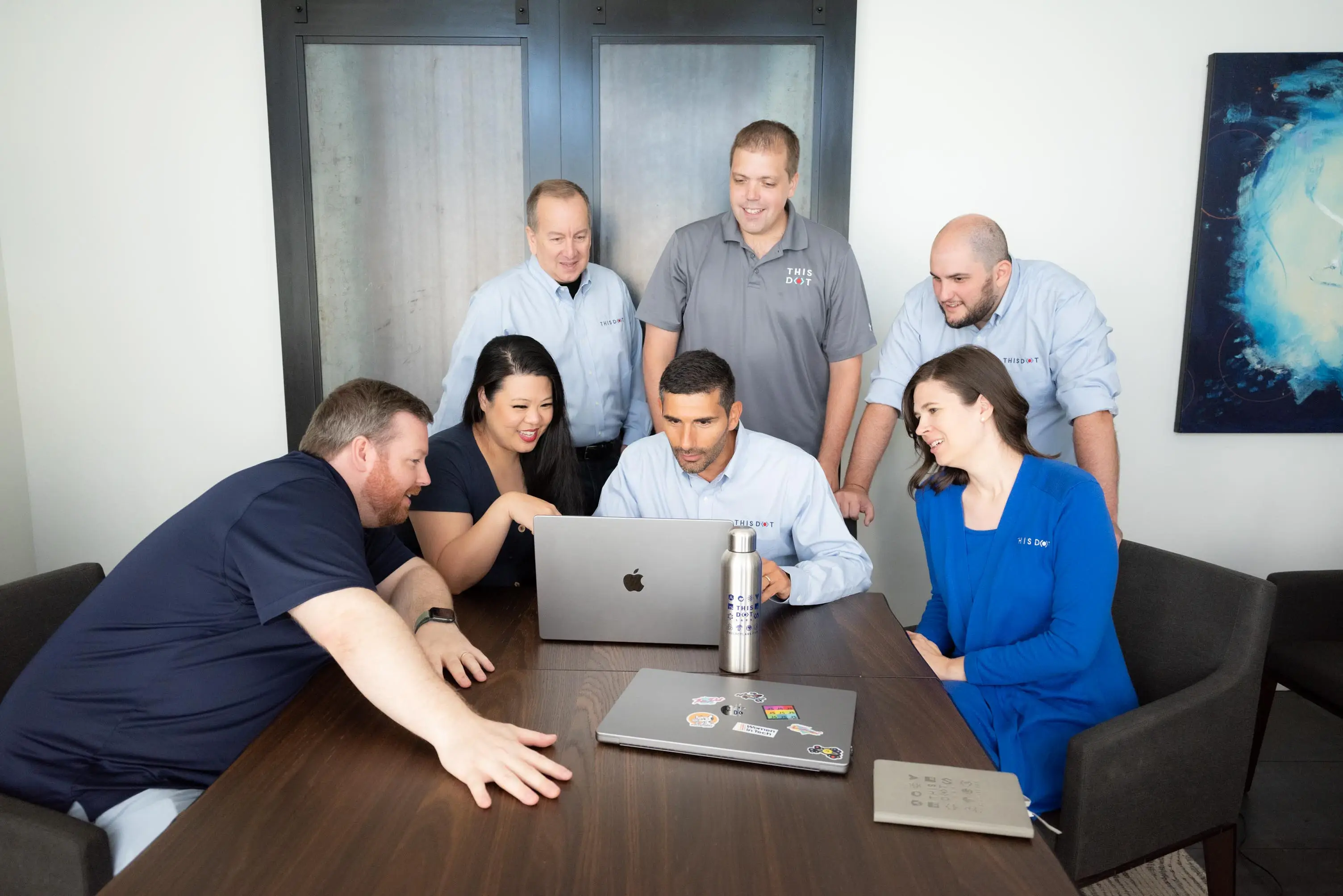 1. This Dot Labs Leadership team looking at a computer screen