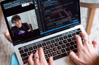 Person attending a live training course while developing the codeof the course